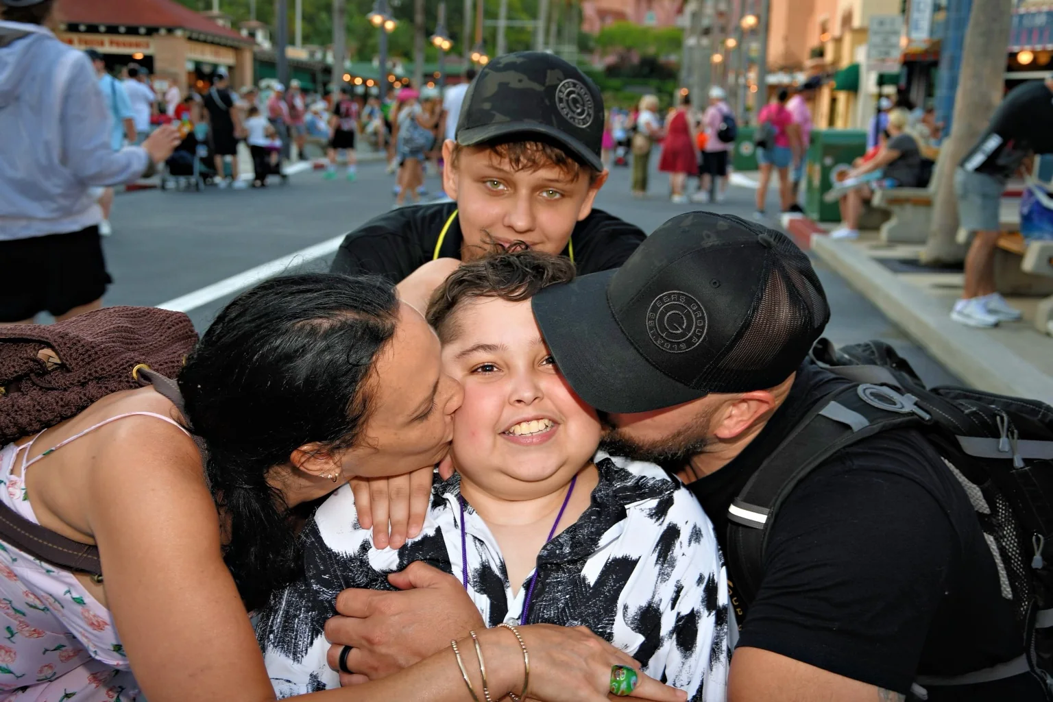 Jack smiling while his family hugs him